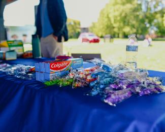 a photograph of giveaways, including toothpaste and candy, at the event